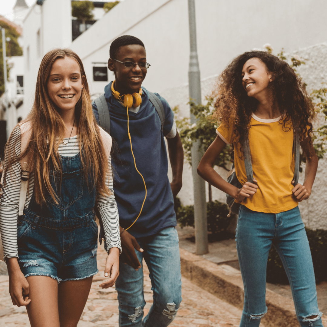 Image: A group of teenagers wearing causal clothes walking together. The mood of the picture a laid back and relaxed and the teens are smiling. PEERS bootcamp